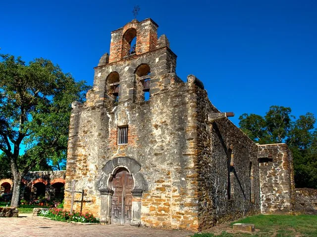 Mission Espada stone church with three bells in the campanario