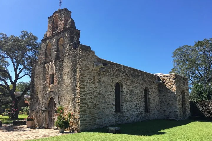 Mission Espada stone church with bell tower on a sunny day